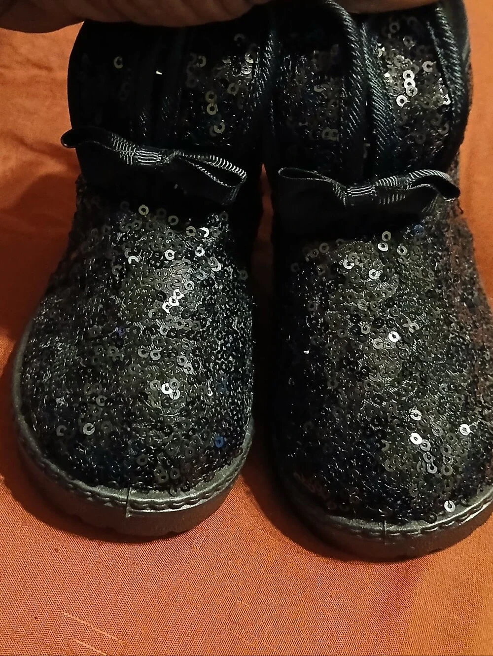 black sequin children's ankle boots with decorative bows and flat fur sole